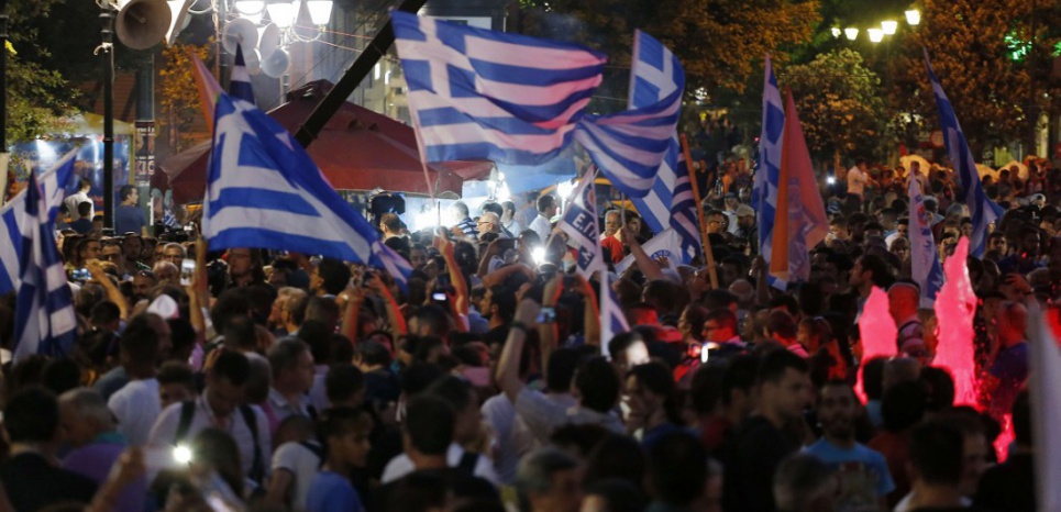 Supporters of the No vote wave Greek flags after the first results of the referendum at Syntagma square in Athens, Sunday, July 5, 2015. Greece faced an uncharted future as officials counted the results of a referendum Sunday on whether to accept creditors' demands for more austerity in exchange for rescue loans, with three opinion polls showing a tight race with a narrow victory likely for the "no" side. (AP Photo/Emilio Morenatti)/XTS211/74046270032/1507052026